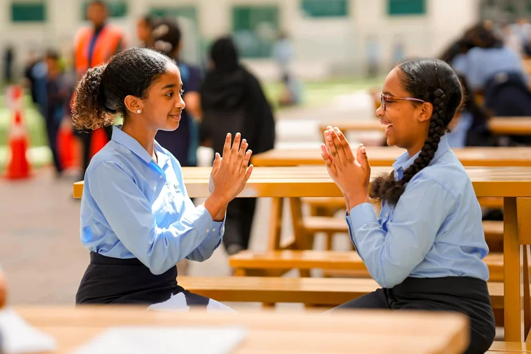 two students playing with hands